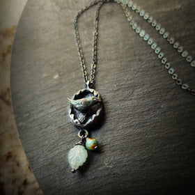 hope is the thing with feathers amulet